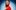 MT_SAMARAJOY_SHOT2-121_AS_re_PROOF Samara Joy stands in red outfit looking to the side against a blue backdrop